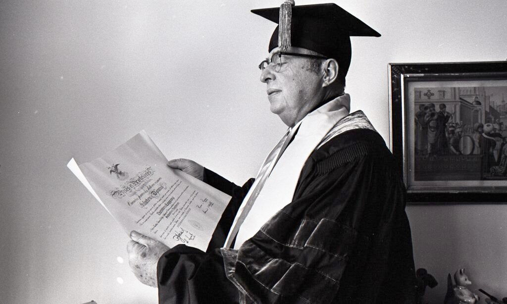 Koppanyi holding his honorary degree.